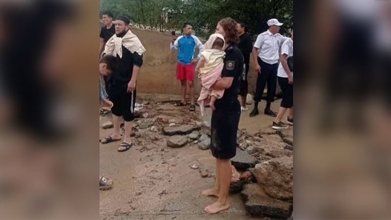 Одним кадром: босая сотрудница милиции держит ребенка после схода селевых потоков в Оше